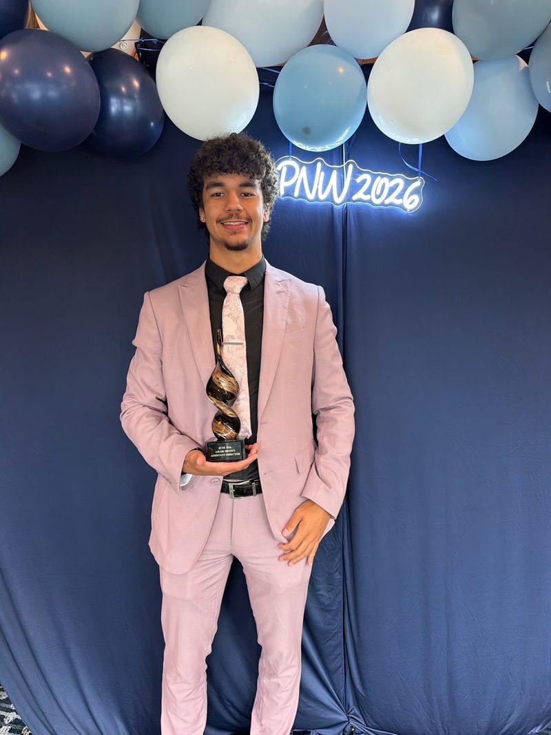 A Chosen Innovations team member holding an award at a company recognition event