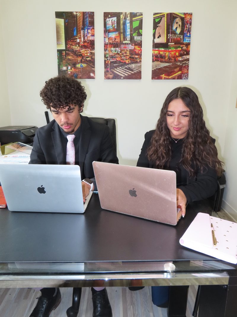 Two Chosen Innovations team members reviewing campaign strategy on laptops