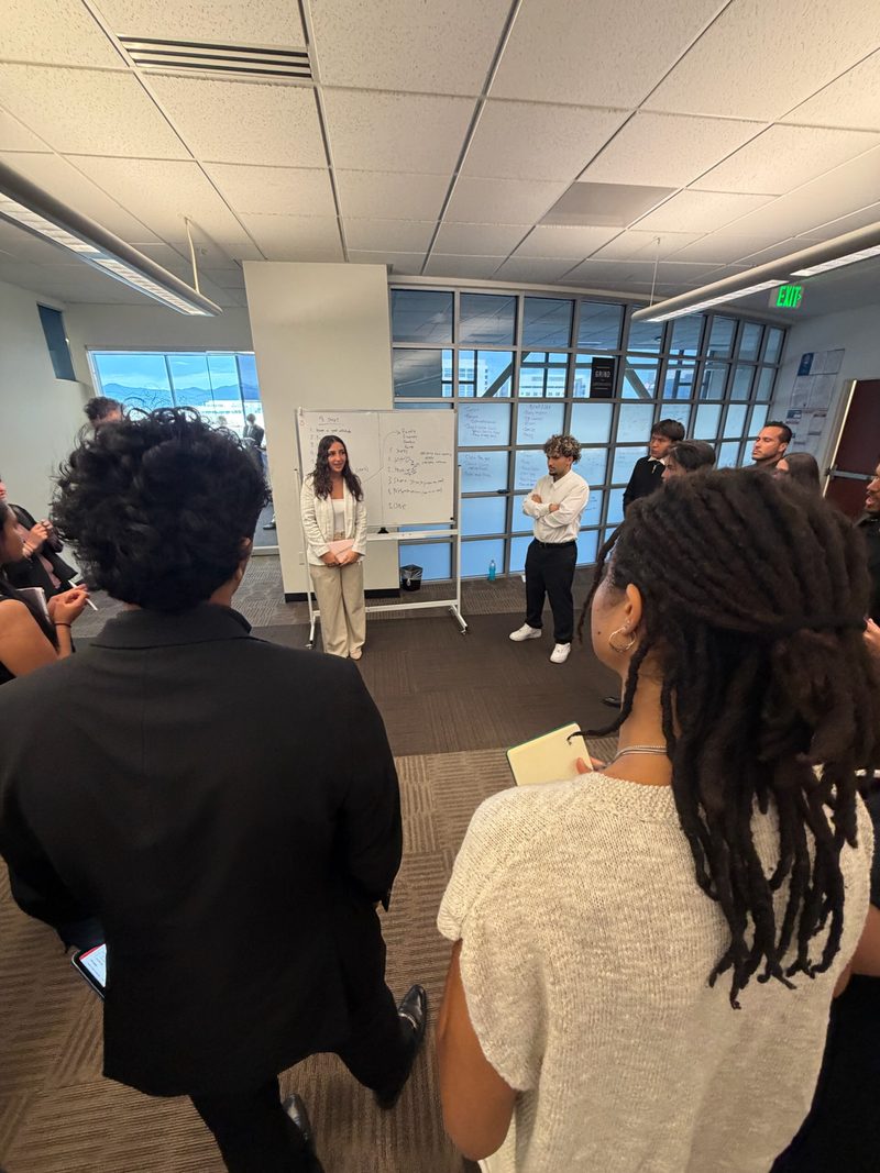 A Chosen Innovations trainer reviewing campaign performance in front of a whiteboard